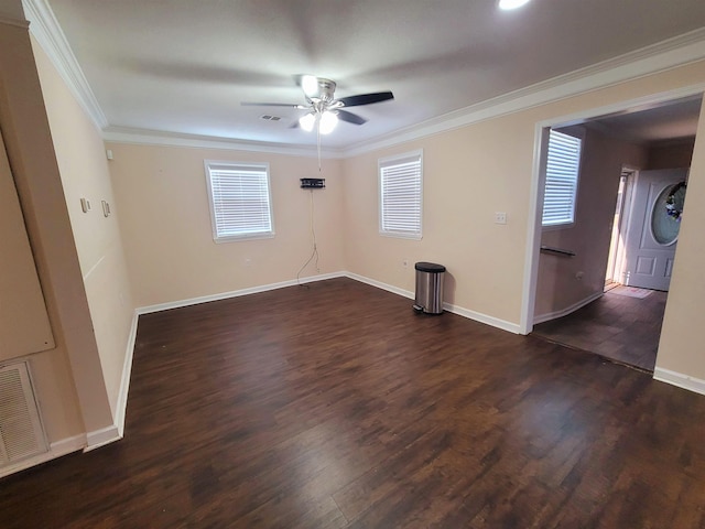 spare room featuring dark hardwood / wood-style floors, ceiling fan, and crown molding