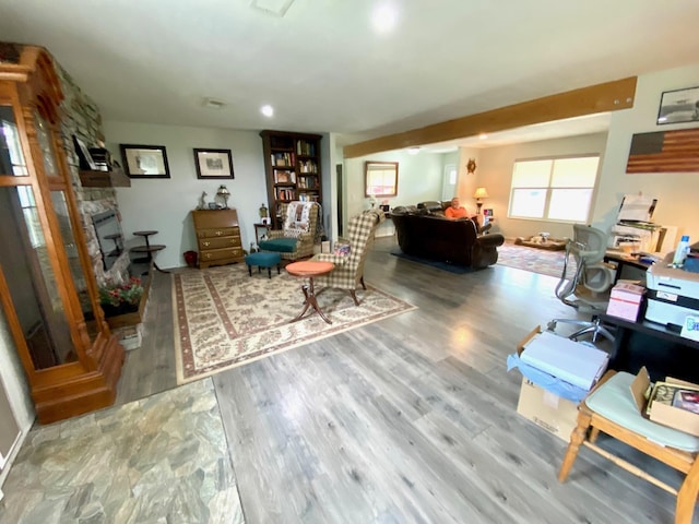 office space featuring hardwood / wood-style flooring and a stone fireplace