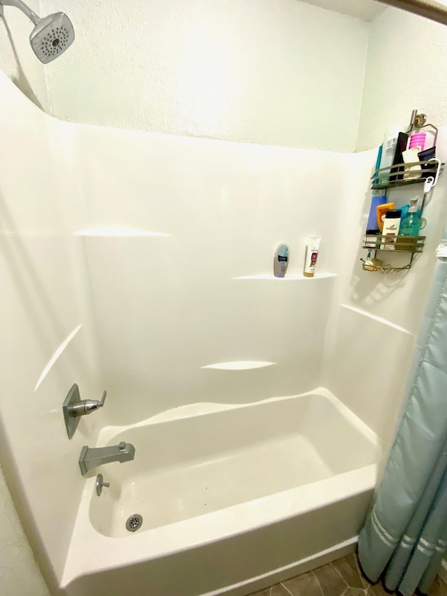 bathroom featuring tile patterned floors and shower / bath combination with curtain