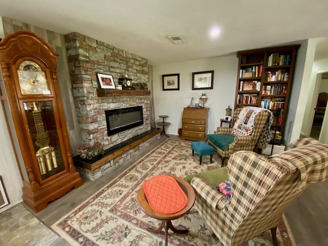 sitting room with a stone fireplace