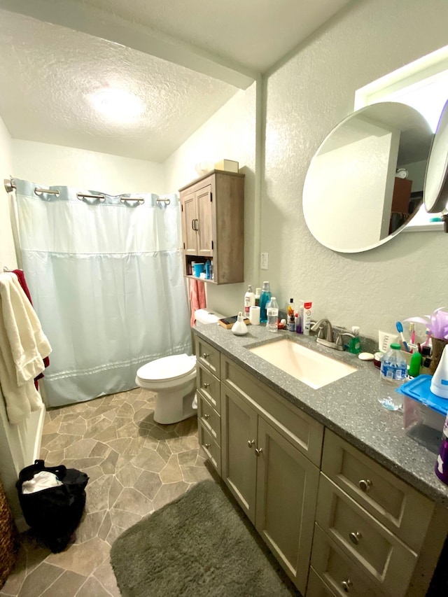 bathroom featuring vanity, a textured ceiling, toilet, and a shower with shower curtain