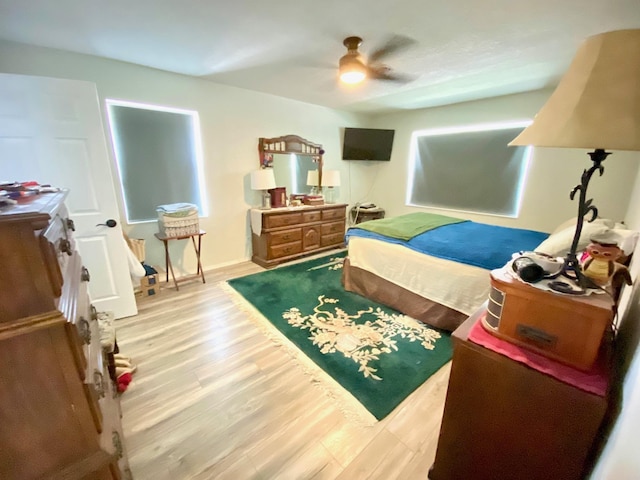 bedroom with hardwood / wood-style floors and ceiling fan