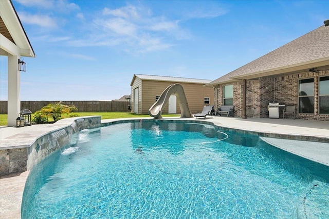 14770 Bond Rd, Beaumont, TX 77713 - view of pool featuring a patio, an outdoor structure, pool water feature, and a water slide