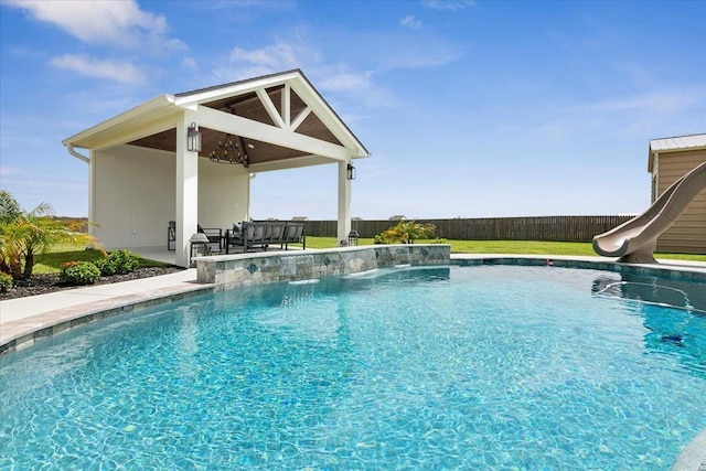 14770 Bond Rd, Beaumont, TX 77713 - view of swimming pool featuring a water slide, a patio, and ceiling fan