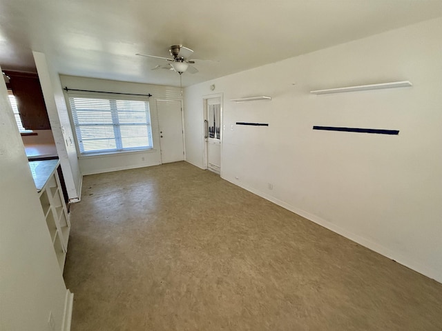 spare room featuring concrete flooring and ceiling fan