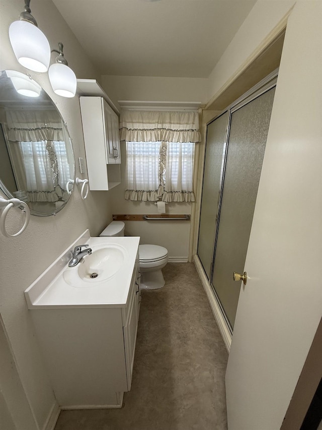 bathroom with vanity, toilet, and walk in shower