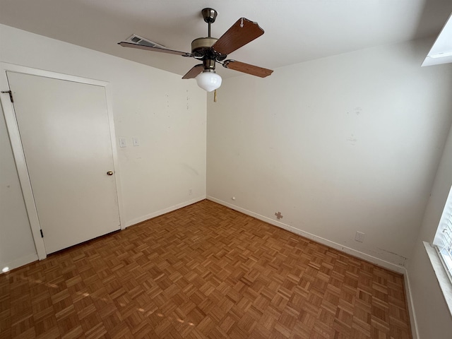 unfurnished room with parquet floors and ceiling fan