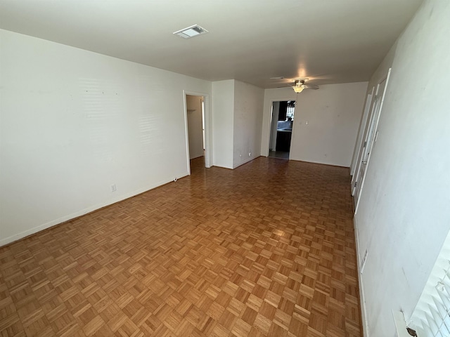 unfurnished room with parquet floors and ceiling fan