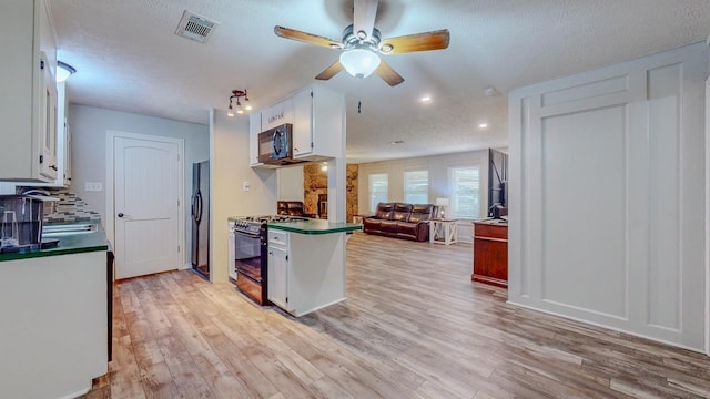 2418 Saba Ln, Port Neches, TX 77651 - kitchen featuring black appliances, dark countertops, ceiling fan, white cabinetry, and light wood-style floors