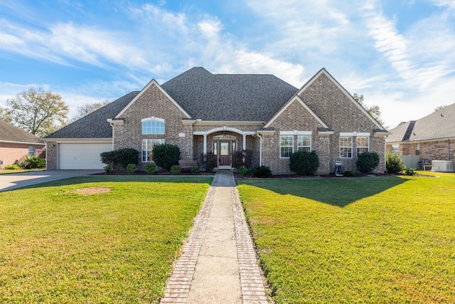 view of front facade with a garage and a front lawn