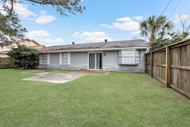 back of house with a patio area, a fenced backyard, brick siding, and a yard