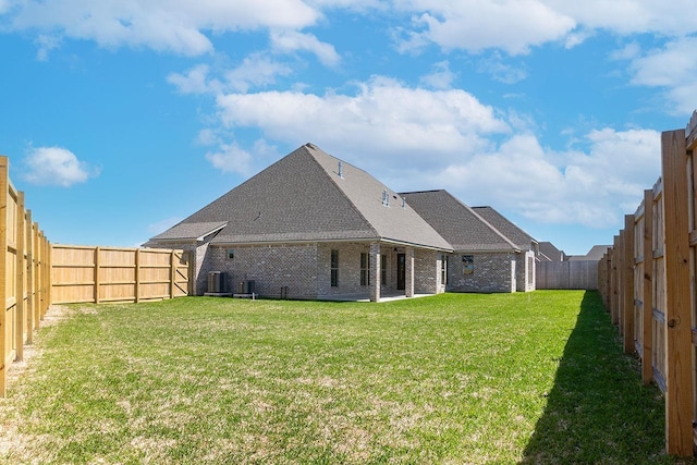 rear view of house featuring a lawn