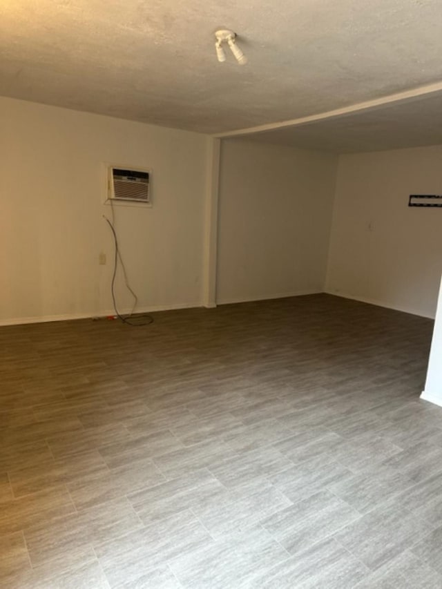 unfurnished room with a wall mounted air conditioner