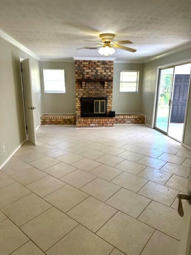 unfurnished living room with ceiling fan, a fireplace, ornamental molding, and a textured ceiling