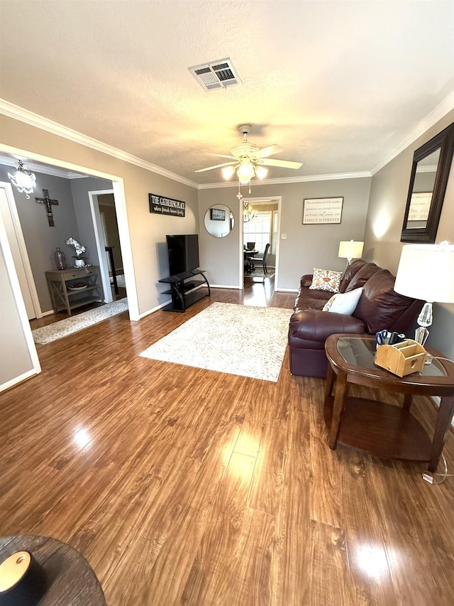 2521 Maple St, Nederland, TX 77627 - living room with wood finished floors, a ceiling fan, and crown molding