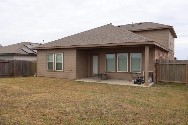 rear view of property with a yard and a patio