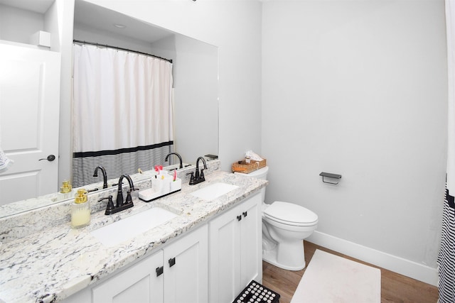 bathroom featuring hardwood / wood-style floors, vanity, and toilet