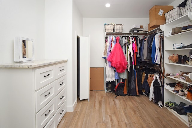 walk in closet with light wood-type flooring