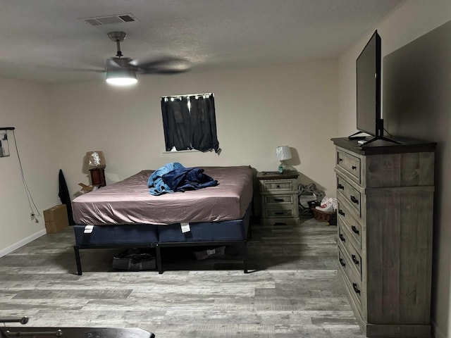 bedroom featuring ceiling fan and wood-type flooring