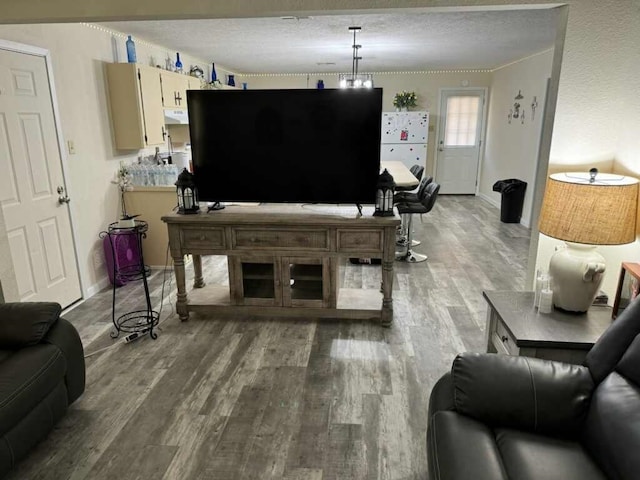 living room with wood-type flooring and a textured ceiling