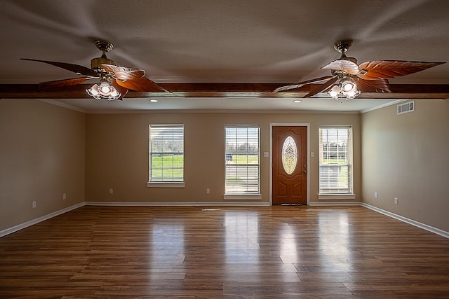 foyer entrance with hardwood / wood-style flooring, plenty of natural light, and ornamental molding