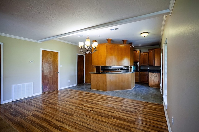 kitchen featuring a textured ceiling, ornamental molding, a chandelier, and dark hardwood / wood-style floors