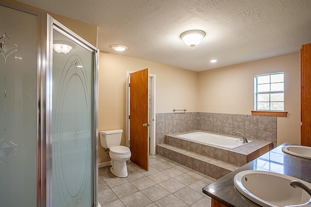 full bathroom with a textured ceiling, vanity, toilet, and tile patterned floors