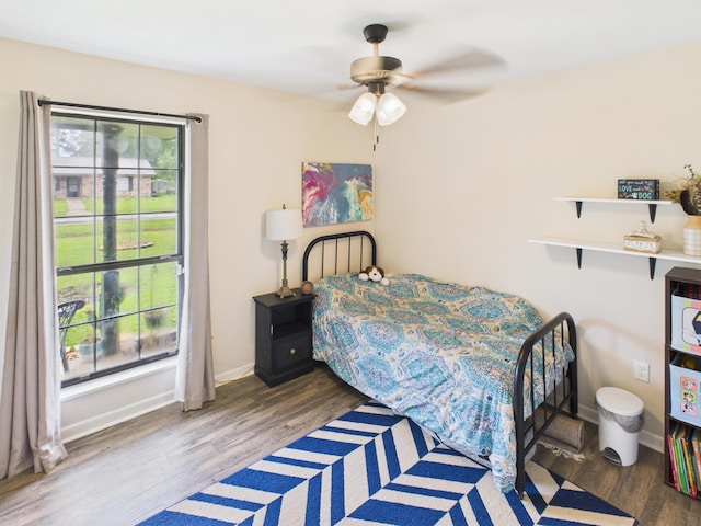 bedroom featuring wood finished floors, ceiling fan, and baseboards