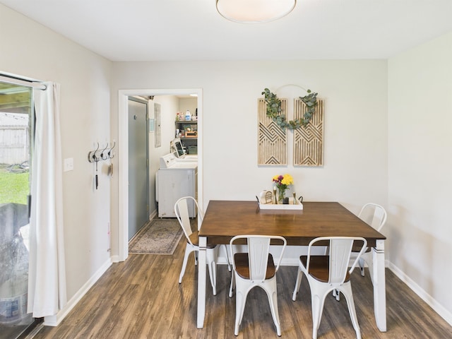 dining room featuring wood finished floors, washer and clothes dryer, and baseboards