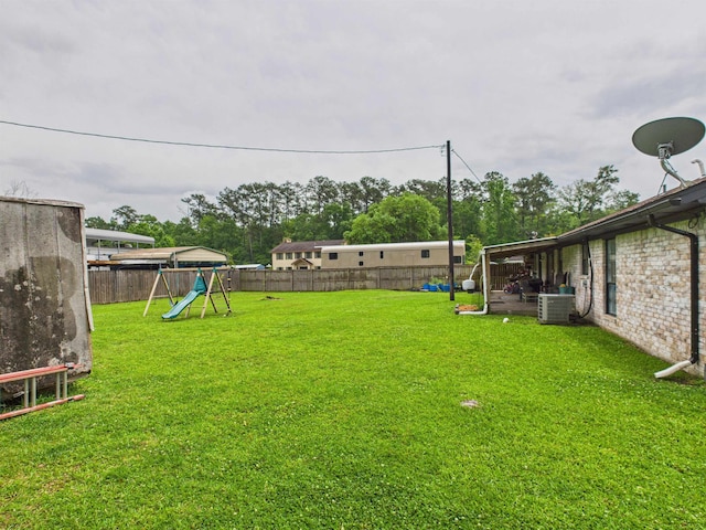 view of yard with a playground and a fenced backyard