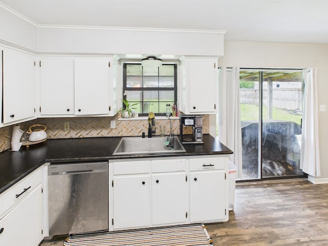 kitchen featuring a sink, stainless steel dishwasher, dark countertops, white cabinets, and wood finished floors