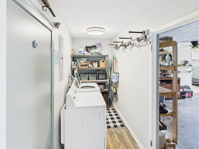 clothes washing area with a ceiling fan, laundry area, and washing machine and dryer