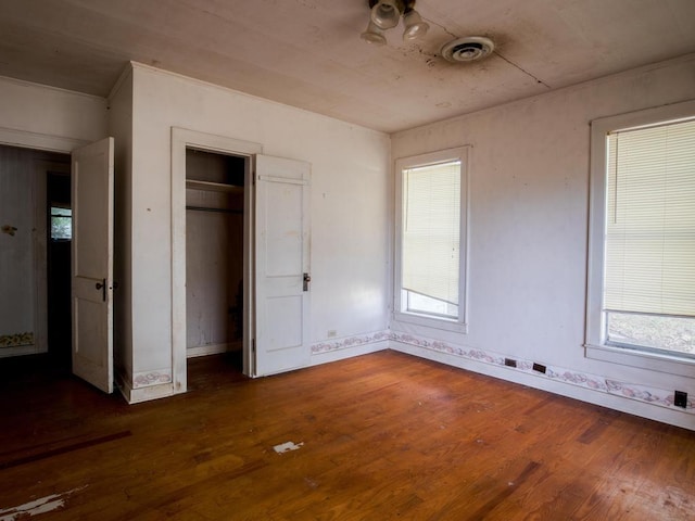 unfurnished bedroom featuring dark hardwood / wood-style floors