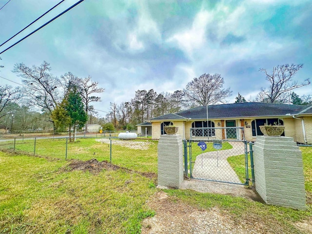 exterior space with a fenced front yard and a gate