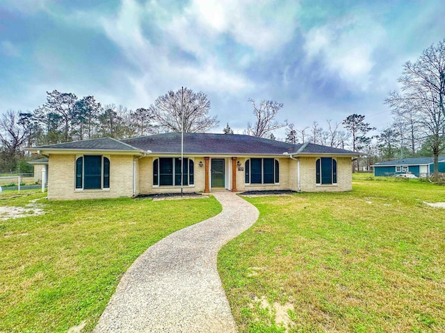 single story home featuring a front yard and brick siding