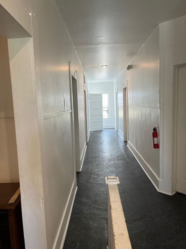 corridor featuring baseboards