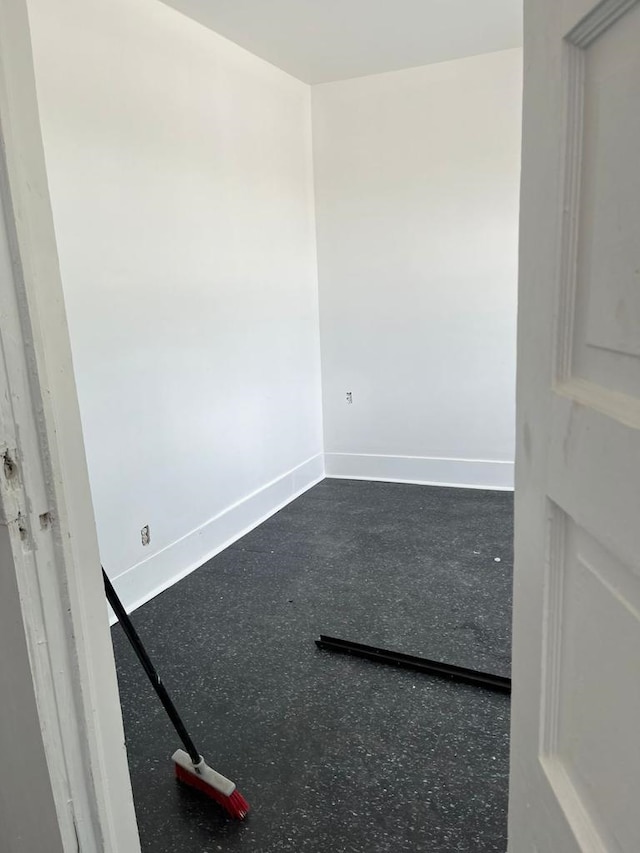 unfurnished room featuring baseboards