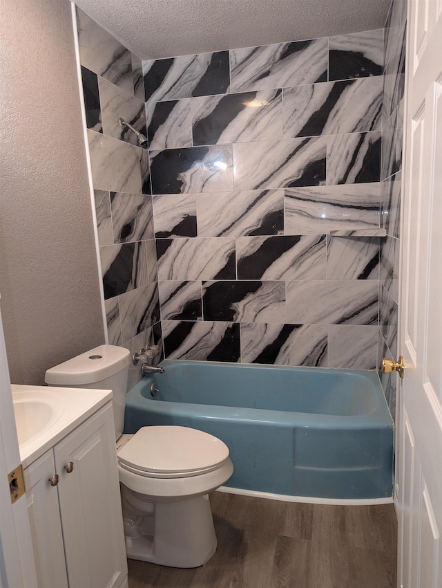 full bathroom featuring hardwood / wood-style floors, vanity, toilet, a textured ceiling, and shower / bath combination