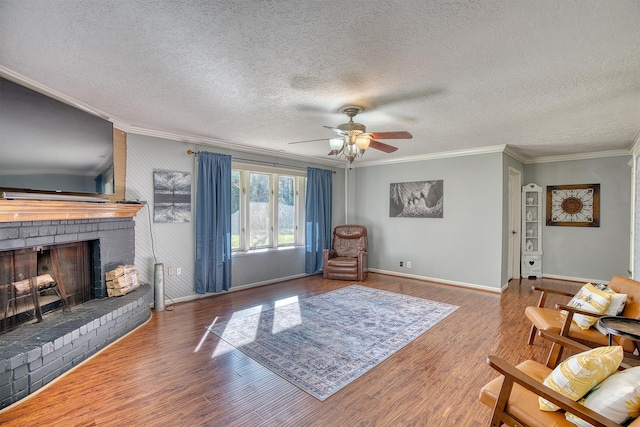 living room with crown molding, a fireplace, a textured ceiling, and hardwood / wood-style flooring