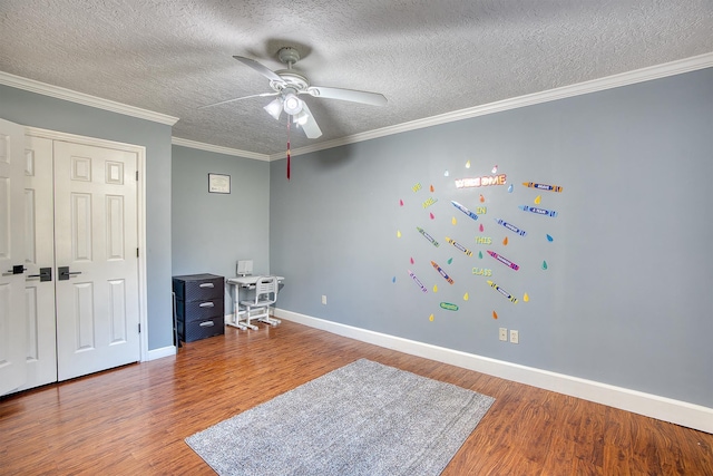 bedroom featuring hardwood / wood-style floors, ceiling fan, ornamental molding, and a textured ceiling