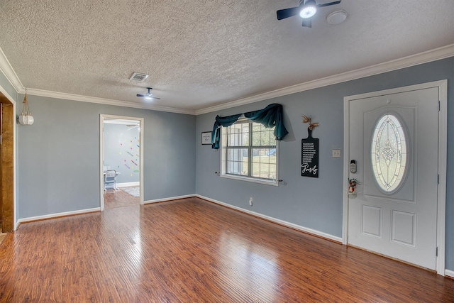 foyer entrance featuring hardwood / wood-style floors, a textured ceiling, ceiling fan, and ornamental molding