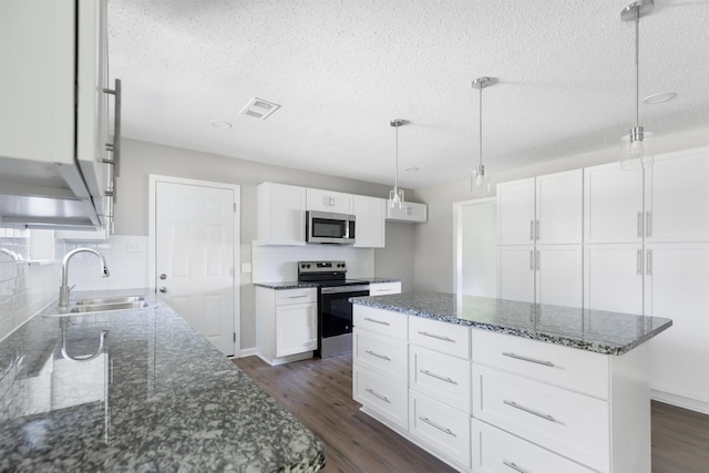 kitchen featuring white cabinetry, a center island, sink, and appliances with stainless steel finishes