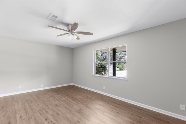 empty room featuring ceiling fan and hardwood / wood-style floors