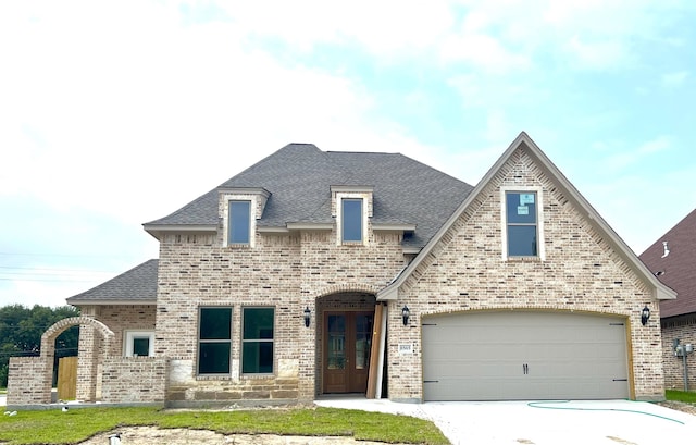 8565 Sana Dr, Beaumont, TX 77713 - french provincial home featuring brick siding, roof with shingles, and concrete driveway
