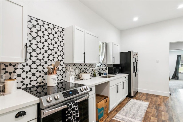 kitchen with sink, stainless steel appliances, dark hardwood / wood-style floors, decorative backsplash, and white cabinets