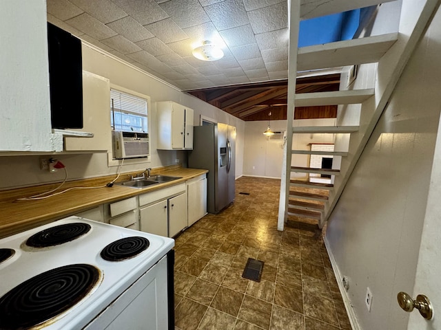 kitchen featuring white electric range, butcher block countertops, white cabinetry, sink, and stainless steel refrigerator with ice dispenser