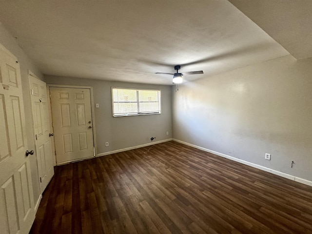 interior space with ceiling fan and dark hardwood / wood-style floors