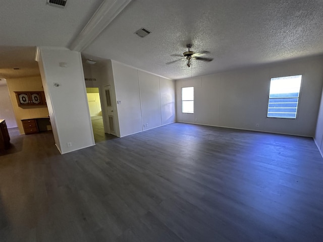 unfurnished room with a textured ceiling, dark hardwood / wood-style floors, and ceiling fan