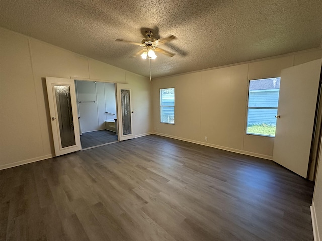 unfurnished bedroom featuring a textured ceiling, ceiling fan, and dark wood-type flooring