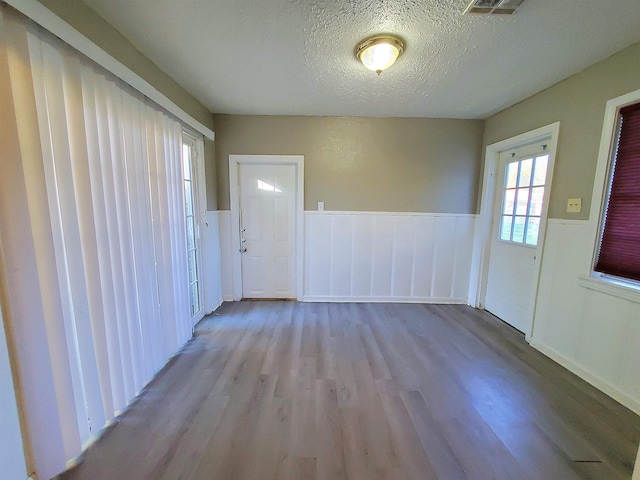 interior space with light hardwood / wood-style floors and a textured ceiling